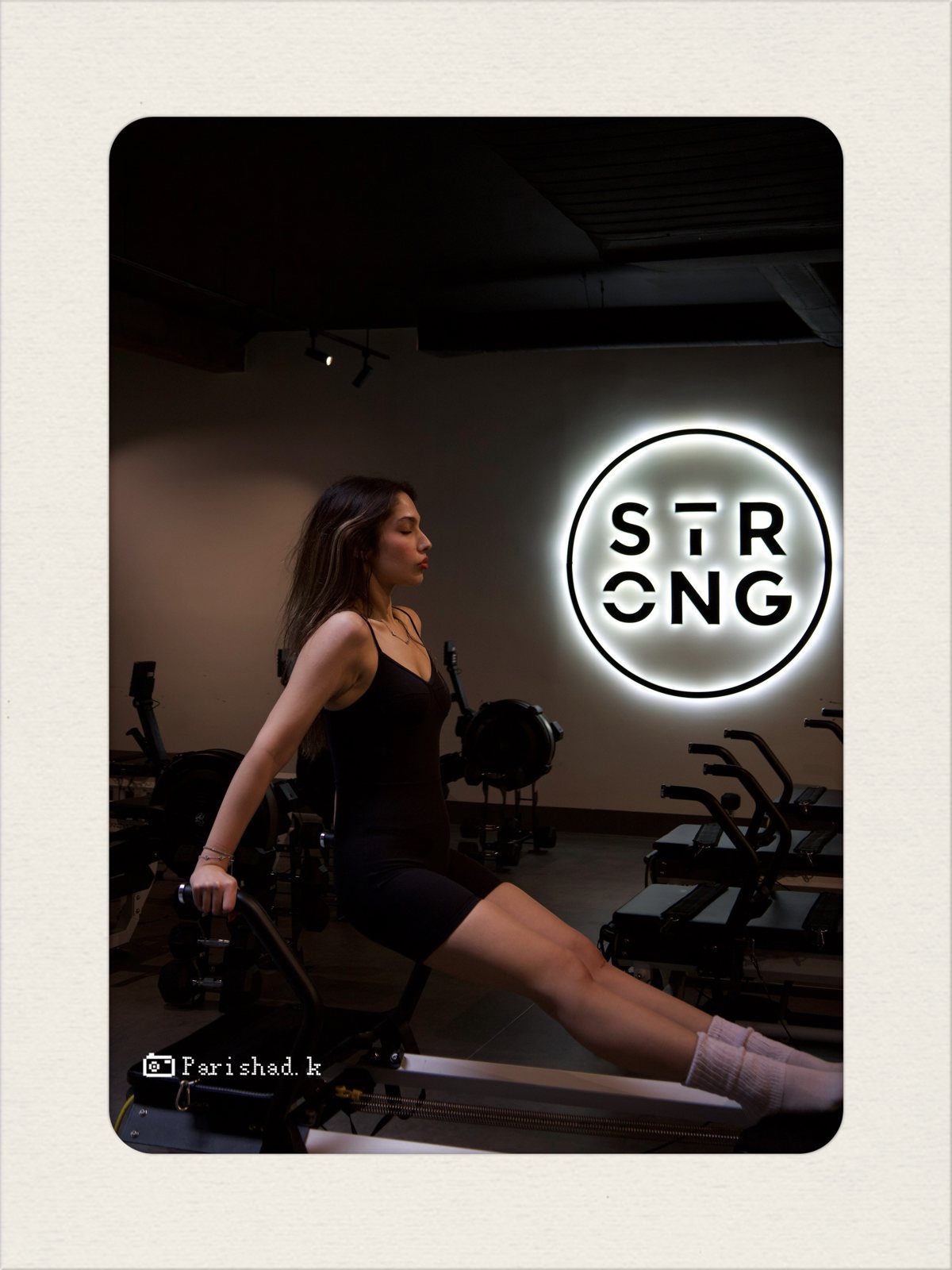 Model on a reformer beside the STRONG sign