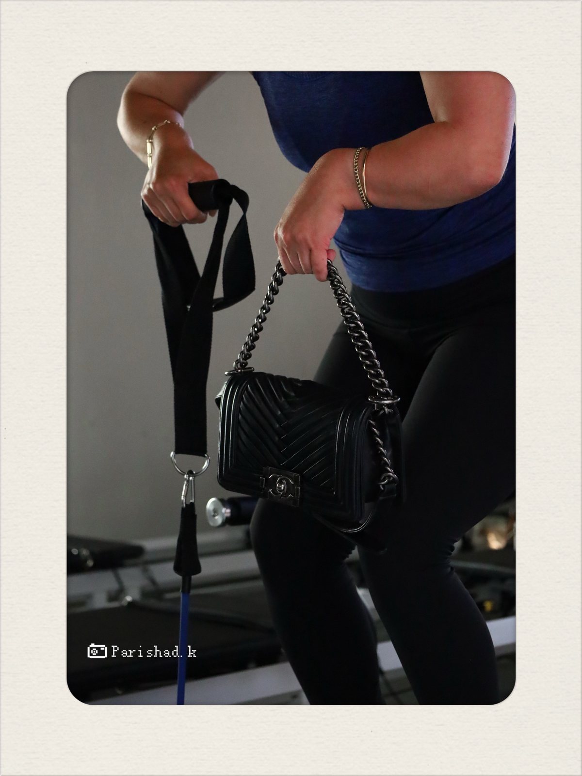 Chanel bag held beside a resistance strap