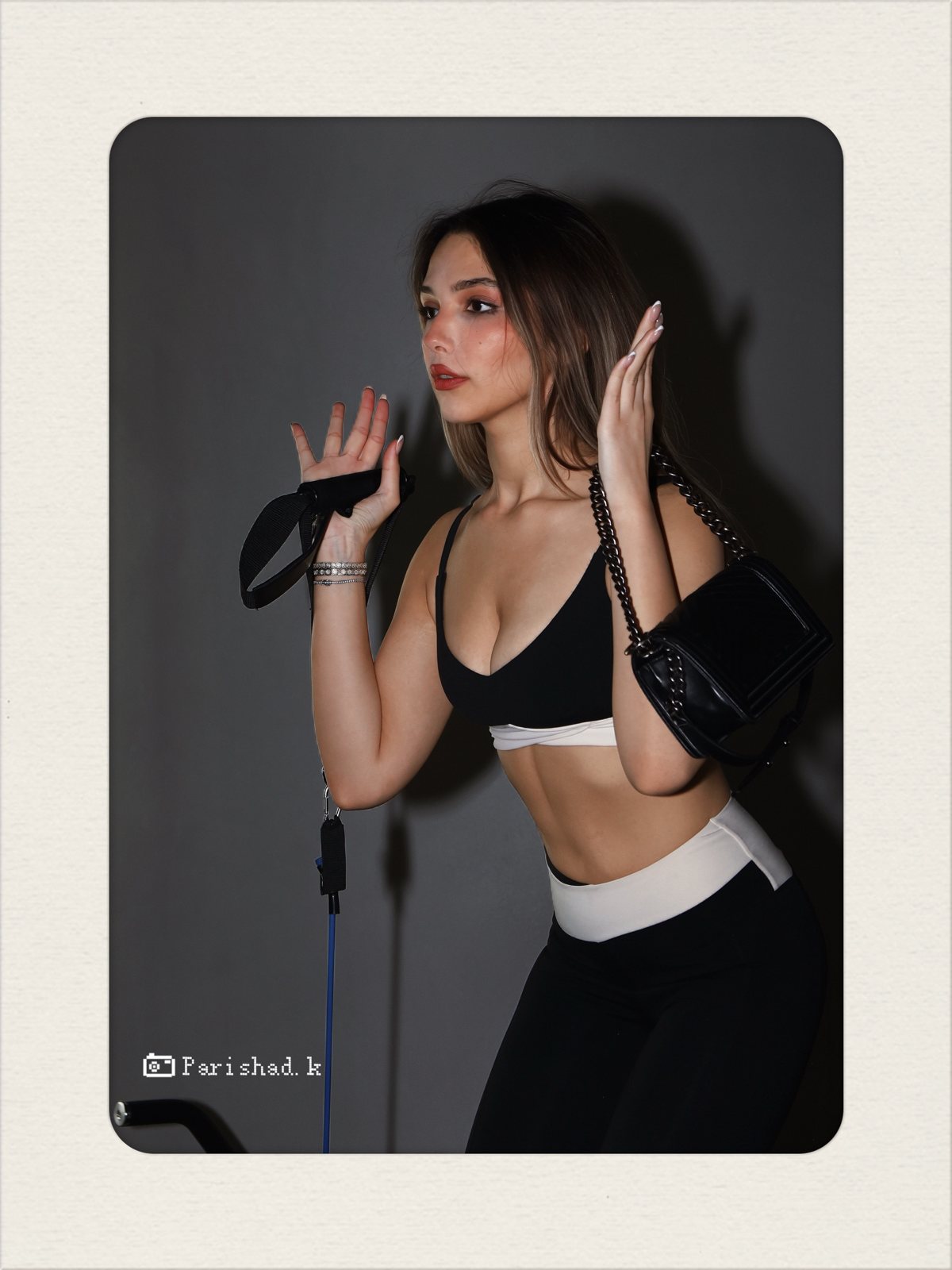 Model with a Chanel bag and resistance band